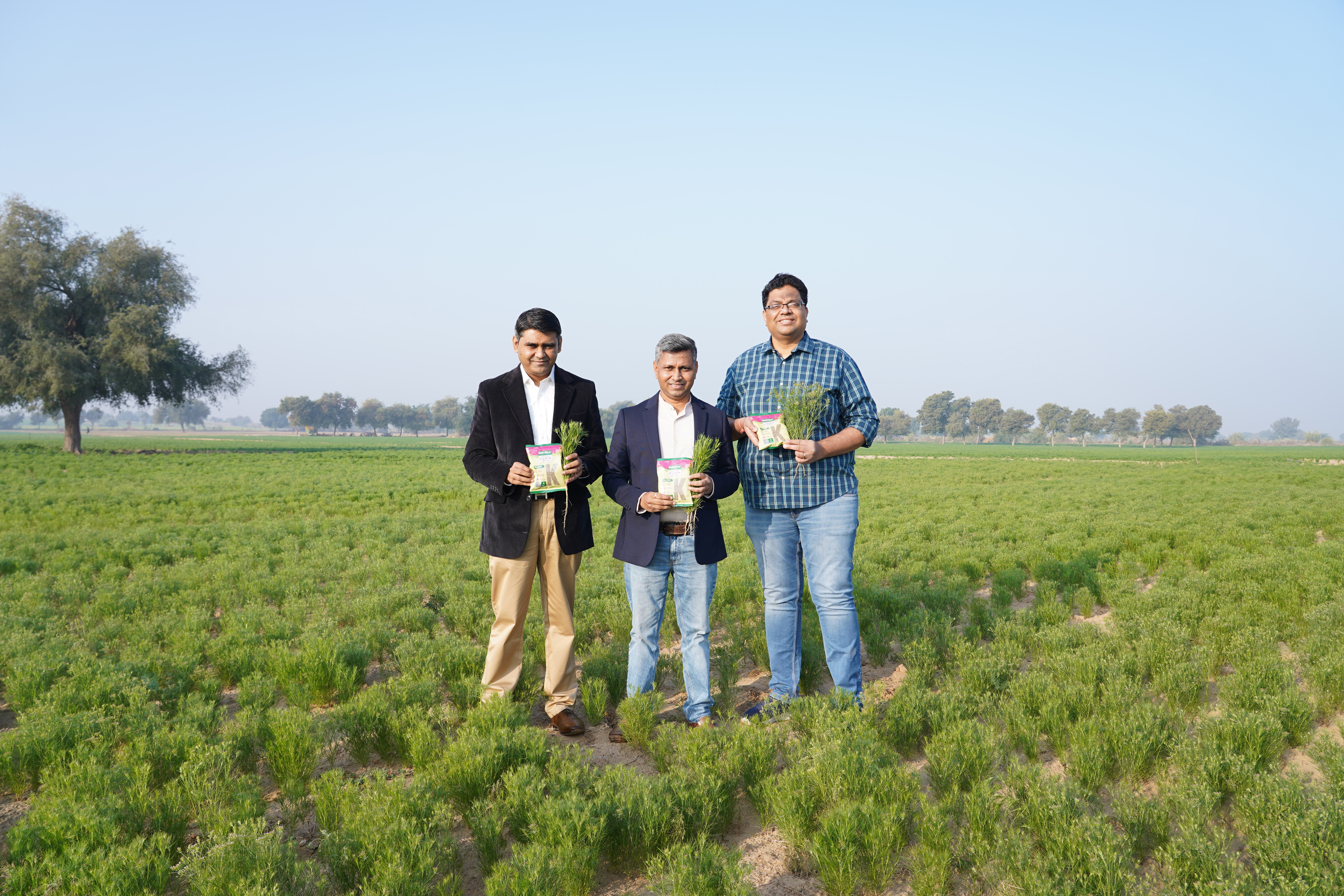 Khetika founders in a green farm field